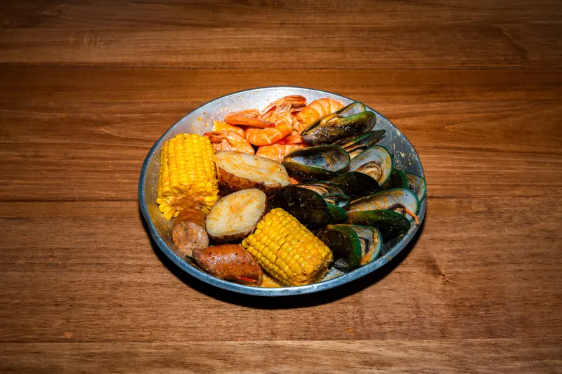 Mussel Combo — green mussels and shrimp with corn, potatoes and sausage in Cajun garlic butter at Big Crab