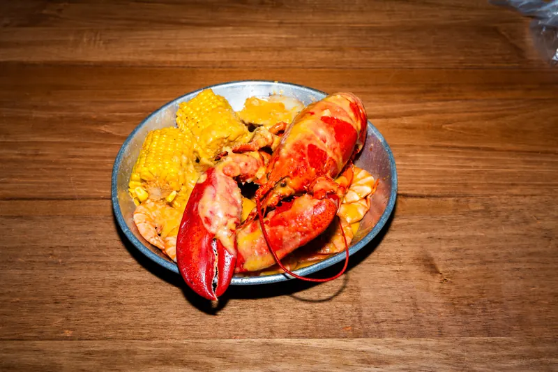 Lobster Combo — whole lobster and shrimp with corn, potatoes and sausage in Cajun garlic butter at Big Crab