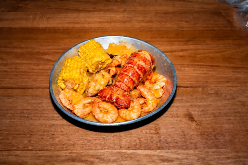 Lobster Tail Combo — lobster tail and shrimp with corn, potatoes and sausage in Cajun garlic butter at Big Crab
